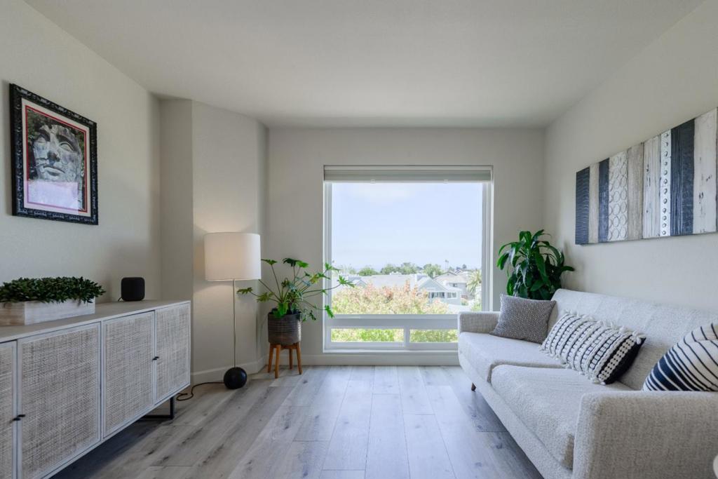 Welcome to this spectacular condo in a coveted development near the ocean with, you guessed it, OCEAN VIEWS right from your living room, family room, bedroom and deck! This home features so much natural light due to not only the expansive floor-plan, but also the numerous double-pane windows throughout including extra side windows due to the fact that this is an end unit with only one neighbor! All living areas have been planned out beautifully with spacious bedrooms and all living areas. The beautiful wood flooring throughout that is very popular today give this home so much class and functionality that also includes durability! Both bedrooms are spacious with plenty of closet space and the primary suite is jaw dropping with its space, seating areas and private bathroom with lots of closet space too. Currently, the primary suite is being used as an entertainment room. Downstairs is a separate family room with a fireplace and access to spacious rear deck and also another bedroom with access to deck. The floor-plan of this home is one of the best you will ever see and experience, so many options and so much thought has gone into the design of this home. Want to go to the beach or play some golf? Heck, you could do both in the same day as it is just down the road!