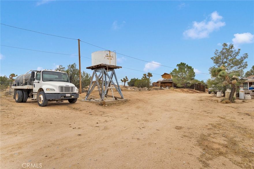 Here is your chance to buy in the desirable “Highlands” area of So. Apple Valley!
A mile or so up the dirt road, you will find this quaint 1994 two bed, one bath with plenty of parking sitting on 2.5 acres.  As you approach down the driveway you see the 1480 sqft covered porch that wraps around to a Car Port and then around to a cozy front covered patio with its peek-a-boo view of the city lights below. This property features a dog run, chicken coop and a two stall horse shelter with tack room and corrals!  There are multiple storages and sheds.  There is also a work shop (tools don’t stay) and an underground 256' root-cellar, separate from the house.  The home is on a well with 6000 gallons of water storage in 2 tanks.  Recent upgrades include a newer 2-3 year old roof and newer 2-3 year old 700’ deep well.  This property has a lot to offer!