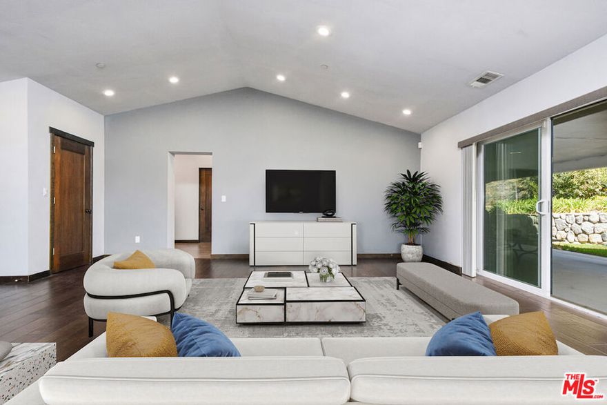 This Awesome ranch style home offers a blend of contemporary design immersed in nature, perched in the hills of Tujunga. Built in 2017 and meticulously well kept, this open-concept, three bedroom and two bathroom retreat is a rare find! Stepping inside, you'll be greeted by the warmth of real Oak hardwood floors, which flow effortlessly throughout the home. A modern kitchen, outfitted with sleek appliances and refined finishes, serve as the heart of the home-perfect for both casual mornings and elegant entertaining. The living area is anchored by a real wood-burning fireplace, creating a cozy ambiance for the cooler nights. Beyond the homes impeccable interior, the private gated driveway ensures both security and seclusion, while dedicated RV parking adds to its practicality. Talk about indoor-outdoor living there is direct access through floor to ceiling glass sliders of which lead to a spectacular patio and sprawling back garden, scattered with flowers and a manicured lawn, a true sanctuary backs up to the majestic mountains and features a natural stream, offering a peaceful oasis where nature and comfort coexist in perfect harmony. This home is more than a residence-its an escape, its an experience, and an opportunity to embrace both modern comfort and breathtaking scenery. An absolute gem in superb condition awaits its next chapter, there is so much room to expand and build up or out. All mounted televisions, brand-new propane washer/dryer and refrigerator are generously included in the sale. Some of the pictures are virtually staged. This property is priced to sell and with the new interest rate cuts is very achievable! Lets get this gem in to escrow.
