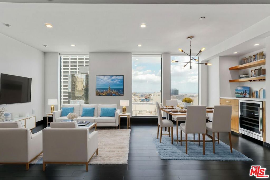 Stunning New York-style Penthouse Loft in the Heart of the Financial District. Come into this striking live/work penthouse loft featuring dark hardwood floors, dramatic floor-to-ceiling windows, and sweeping city views. The fully enclosed bedroom offers added privacy, while custom-built-ins enhance both form and function. Enjoy a designer kitchen and spa-like bath, a spacious walk-in closet, and the convenience of an in-unit washer and dryer. Located in a secure, amenity-rich building with a 24-hour doorman, fitness center, and rooftop deck with BBQ area. Near Whole Foods, Bottega Louie, The Bloc, and with direct metro entrance, this is downtown living at its finest. One gated parking space included.