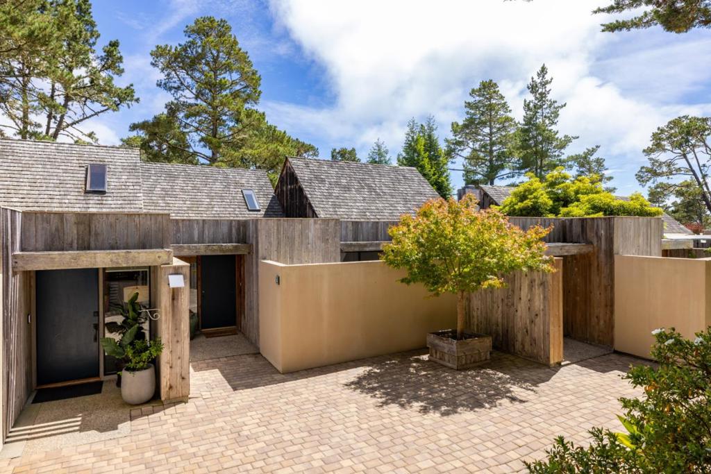 Discover the serene charm of High Meadows with this stunning townhome nestled above the picturesque Carmel-by-the-Sea. Boasting three bedrooms, two bathrooms, and over 1,800 square feet of sunlit living space, this forested retreat is a true gem. The main level invites you in with a spacious primary bedroom opening to a private patio, a bright living area with soaring vaulted ceilings, an expansive deck, and a cozy fireplace perfect for unwinding. The kitchen featuring high ceilings, a large skylight, and an outdoor dining area for al fresco meals. Downstairs, you will find two additional bedrooms, a full bath, a convenient laundry room, and another deck to soak in the tranquil views. Additional perks include a private garage and generous storage space. Situated within the coveted Carmel Unified School District and just moments away from the best of the Monterey Peninsula, this home is a must-see. Experience the allure of High Meadows living!