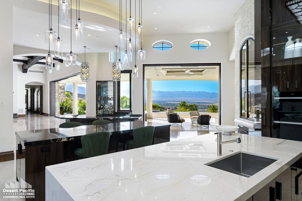 This lavish 8,825 sq. ft. custom estate is nestled on 1.79 acres in the highly exclusive Mirada Estates community. This stunning property features two homes, amounting to six luxurious bedrooms and eight bathrooms, providing ample living space for comfort and privacy. With a detached 8-car garage and a 2-car attached garage. The infinity pool invites you to swim in luxury, accompanied by breathtaking views of the expansive valley below. The floor-to-ceiling moving glass wall systems that seamlessly blend indoor and outdoor living offers panoramic views of scenic Santa Rosa Mountains and the shimmering cityscape below. The estate boasts ''his and hers'' wings with two primary bedrooms, each featuring their own lavish closets and bathrooms, and a built-in sauna for the ultimate relaxation experience. In addition to the grand estate, the property includes a delightful smaller home, featuring two spacious bedrooms, living room, and kitchen area. Located in the exclusive Mirada Estates, adjacent to the Ritz Carlton Rancho Mirage, this small enclave offers a wealth of benefits. Residents enjoy significant discounts at the Ritz Carlton restaurants, as well as access to luxurious amenities, premium catering services, and accommodations, all at reduced rates. The 24-hour guard-gated community ensures privacy and security, while breathtaking 360-degree views of the Coachella Valley and stunning desert landscapes and wilderness surround you.