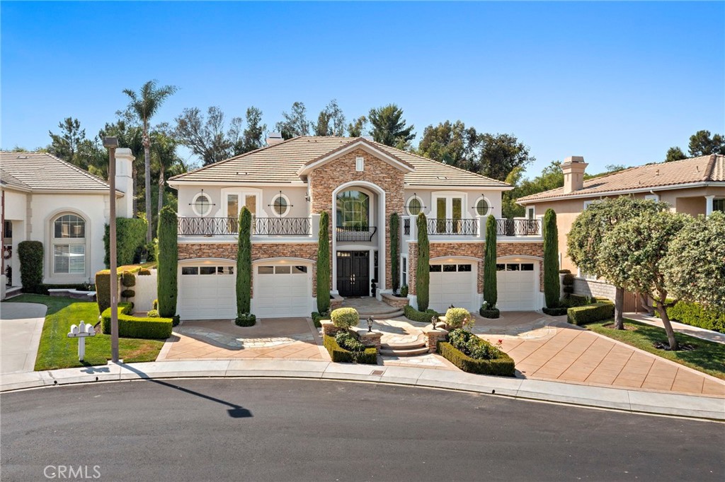 Welcome to Grand Coto Estates. Situated on a Private Cul-De-Sac with Close Proximity to the Gate, enjoy Resort-Style Amenities in this magnificent property. Boasting an expansive 14,000 square feet lot, this home offers unparalleled privacy and space. Step inside through double door entry to a gracious foyer, revealing formal living and dining rooms ideal for sophisticated entertaining. The kitchen, opening to the family room, features a large center island, built-in stainless steel appliances, a spacious walk-in pantry, and a bright breakfast nook. Adjacent, open family room provides a cozy retreat with a fireplace and custom built-ins for your entertainment system. This versatile floor plan includes a convenient main floor bedroom with a private bath and walk-in closet, perfect for guests or multi-generational living. A dedicated den/office with a built-in bookcase and French doors offers a quiet workspace and can be converted into a Sixth bedroom, opening directly to the serene private yard. Upstairs, the luxurious primary suite with a double-door entry, an oversized retreat, and a cozy fireplace. French doors lead to a large private balcony, offering inviting views of the meticulously landscaped backyard. The spa-like primary bath features a separate shower and soaking tub, dual sinks, a vanity, and an oversized walk-in closet with custom organizers. Generously sized secondary bedrooms each include their own private baths, ensuring comfort and privacy for everyone. The resort-style backyard is an entertainer's paradise, showcasing a sprawling grassy area, a gated Pebble Tec pool and spa, and a half basketball court. Enjoy al fresco dining with the built-in BBQ and eating bar. Completing this exceptional property is an oversized 4-car garage. Enjoy access to world-class amenities Coto de Caza Golf and Racquet Club (optional memberships available), equestrian facilities, hiking trails, and more.