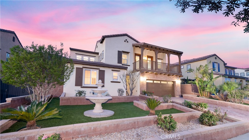 Located in the heart of the highly sought-after Avellino community in North Fontana, this home offers the perfect blend of comfort, elegance, and practicality. Every room is thoughtfully designed to embody modern luxury, with attention to detail and quality finishes throughout. As you approach the home, you're welcomed by an inviting stamped concrete driveway that leads to a spacious 2-car garage. The water-efficient, low-maintenance landscaped yard beautifully frames the property, while a charming balcony graces the front of the house, offering a serene spot to take in the surroundings. Upon entering, you're greeted by rich engineered wood flooring that stretches across the open-concept floor plan. The family room, featuring a cozy fireplace and a well-appointed wall unit for additional storage, creates a perfect balance of expansive living space and comfort. The kitchen, the heart of the home, is designed for both functionality and style. It boasts a large center island, a 5-burner cooktop with a powerful range hood, a built-in oven and microwave, a refrigerator, and a spacious walk-in pantry. Just nearby, a dedicated office space with built-in desks and cabinetry offers a peaceful retreat for work or study. Conveniently located on the first floor, a guest bedroom and bath with a walk-in shower is perfect for hosting overnight visitors or accommodating in-laws, offering both comfort and privacy. Upstairs, a large loft area opens to the front balcony, providing a versatile space. The luxurious primary suite is a true sanctuary, complete with a private balcony offering stunning mountain views. The suite also features a spacious walk-in closet with custom-built-in organizers, ensuring ample storage. The primary bathroom includes a separate walk-in shower, a jetted soaking tub, and dual sinks. The backyard is designed for both relaxation and entertainment, with a California Room that features a ceiling fan for added comfort. The stamped concrete surrounding the space offers easy maintenance, while creating an ideal setting for outdoor gatherings or quiet moments of retreat. Every detail of this home has been carefully crafted, from the elegant engineered wood flooring and recessed lighting to the crown molding, plantation shutters, and custom cabinetry. The result is a space that seamlessly combines beauty and functionality, creating a home that is as practical as it is stunning.