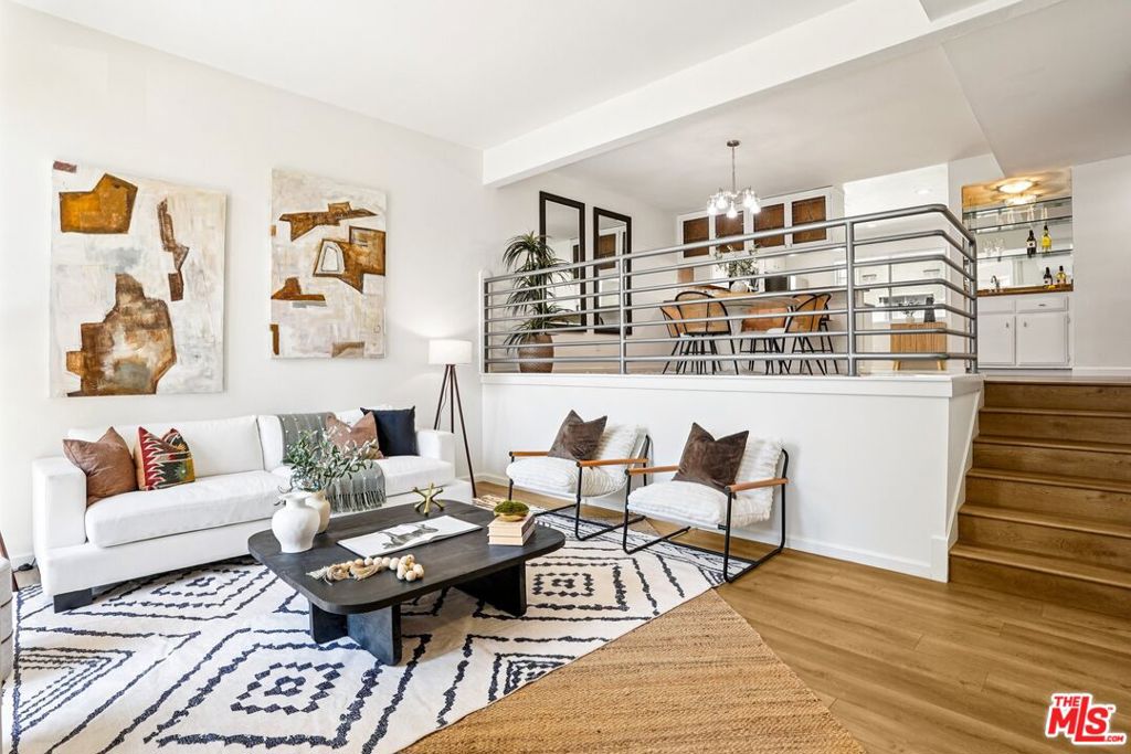 Experience coastal elegance at a stylish tri-level townhome tucked within the coveted Villa Velletri community of Marina del Rey. This spacious two-bedroom, three-bath home combines well-planned architecture with modern updates, offering a bright, inviting atmosphere. Inside, you'll find tall ceilings, brand-new hardwood floors, and freshly painted interiors that create a crisp, contemporary feel. The split-level layout is designed for both comfort and entertaining. A formal dining area overlooks the sunlit living room, where a cozy fireplace and sliding glass doors open to a private patio. Here, you can enjoy al fresco dining, morning coffee, or evening gatherings while savoring the refreshing coastal breeze. Just off the dining area, a built-in wet bar adds a touch of elegance perfect for mixing cocktails, serving wine, or creating a stylish coffee station when entertaining guests. An in-unit laundry room with side-by-side washer and dryer also makes daily living seamless. Upstairs, you'll find two bedrooms, each with their own en-suite bathroom. The light-filled primary suite offers tall ceilings, abundant closet space, and a private bath retreat, while the second en-suite bedroom works beautifully as a guest suite, office, or creative studio providing flexibility to suit any lifestyle. Additional highlights include 2.5 bathrooms in total, a private two-car garage with extra storage, and direct home access for convenience. Within Villa Velletri, residents enjoy a rare sense of tranquility. Meandering pathways, mature landscaping, and leafy canopies create a peaceful backdrop that feels worlds away from the city. The community is complemented by resort-style amenities including four sparkling pools, soothing spas, a welcoming clubhouse, and abundant guest parking all designed to elevate everyday living. Beyond the community, the best of Marina del Rey living awaits. Enjoy the coastal lifestyle just minutes from sandy beaches, the marina, and the scenic bike path. Nearby, discover trendy cafes, gourmet restaurants, and boutique shops, or catch the latest release at the AMC Dine-In Marina theater. For convenience, Tesla Supercharging stations are close at hand, and the weekly Farmers Market nearby brings fresh local flavors to your doorstep. This is a rare opportunity to own a stylish townhome in one of Marina del Rey's most desirable communities where serenity, convenience, and coastal charm come together seamlessly.