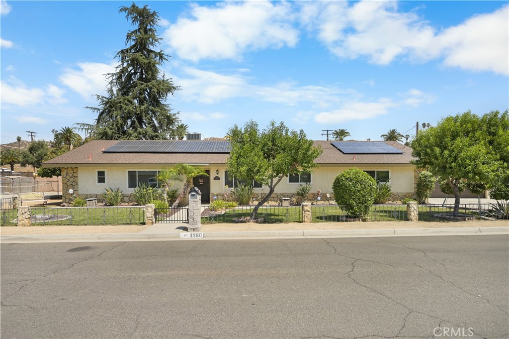 Nestled in the heart of Hemet, CA, this charming single-story home offers an idyllic retreat with a harmonious blend of comfort and style. This 4-bedroom, 2.5-bath residence features exquisite exposed beams in the dining room, adding a touch of rustic elegance to your family gatherings. The spacious living area boasts a large fireplace, perfect for cozy evenings. Outdoors, a beautifully landscaped yard invites you to unwind, with a sparkling pool and spa providing a luxurious oasis for relaxation. Entertain guests with ease at the wet bar, and enjoy ample storage space in the oversized garage. Located in a vibrant community, this home is close to local attractions such as the Western Science Center, Diamond Valley Lake, and the Ramona Bowl Amphitheatre, offering a variety of recreational and cultural activities. Whether you're seeking tranquility or adventure, this Hemet gem provides the perfect backdrop for your Southern California lifestyle.