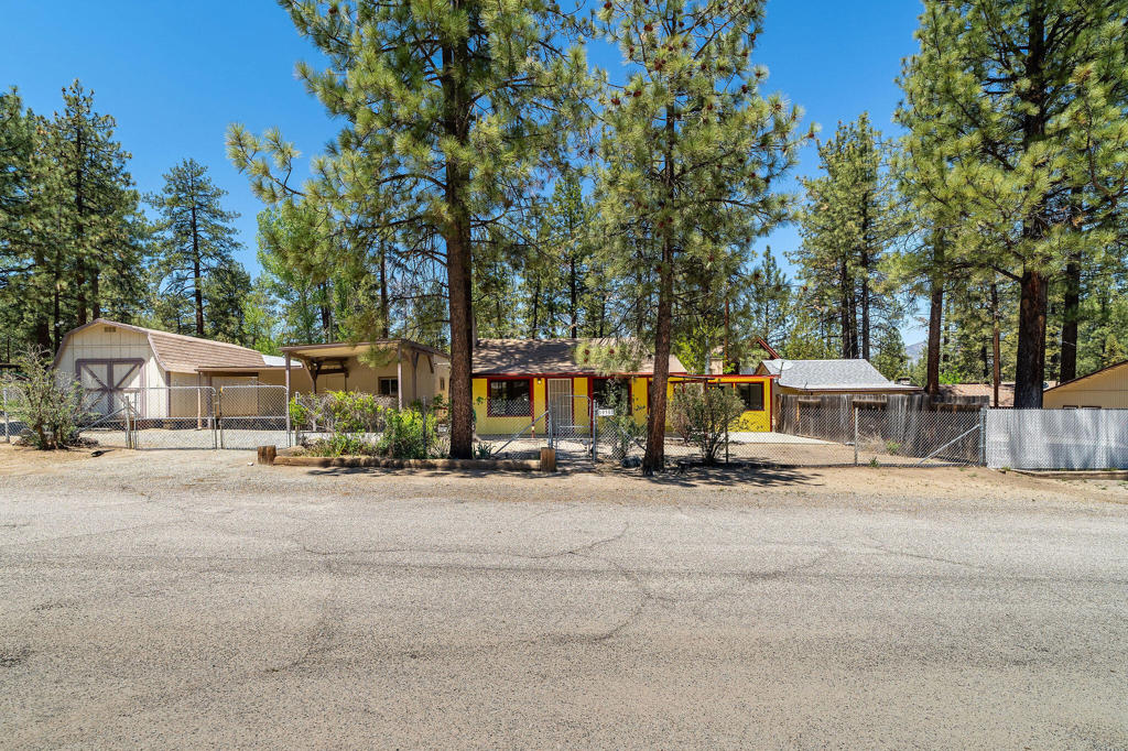 Don't miss this unique opportunity to own a well-maintained 1-bedroom, 1-bathroom home situated on a fully fenced 0.20-acre corner lot. Ideal for downsizers, first-time buyers, or anyone looking for a manageable home with extra space to work, store, and play. Step inside to find a cozy living space warmed by a pellet stove, a walk-in closet, a dedicated laundry room, and all appliances included for your convenience. The layout is functional and efficient, making it easy to maintain and enjoy. Outside, the property truly shines with a large storage shed, a carport, a small workshop-perfect for hobbies or projects-and RV storage with plenty of room to park your toys or tools. The fully fenced yard offers privacy, security, and space for pets, gardening, or entertaining. Whether you're seeking a quiet retreat or a low-maintenance home base with bonus features, this versatile property checks all the boxes. Schedule your tour today!