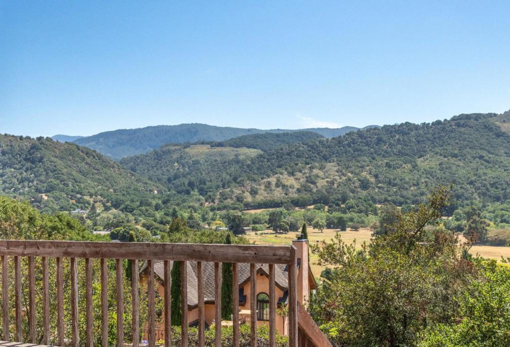 Views, Views, Views! Welcome to this charming 3-bedroom, 2-bathroom home nestled in scenic Carmel Mid Valley, offering 1,648 square feet of comfortable living space. The kitchen includes an eat-in dining area with a built-in bench, perfectly positioned to frame the breathtaking valley views. The living area is filled with natural light, thanks to walls of windows showcasing sweeping vistas of the mountains and valley. Upstairs, you'll find the primary suite, filled with light and privacy. The home also includes an indoor laundry room, central air conditioning, and central forced-air heating for year-round comfort. Outside, enjoy a two-car attached garage, a finished 760-square-foot basement that works perfectly as a hobby room or workshop, and an Tesla power wall battery. Located within the Carmel Unified School District and just minutes from the Mid Valley Shopping Center, Carmel Valley Ranch, and Garland Park, this home is your gateway to the best of Carmel Valley living.