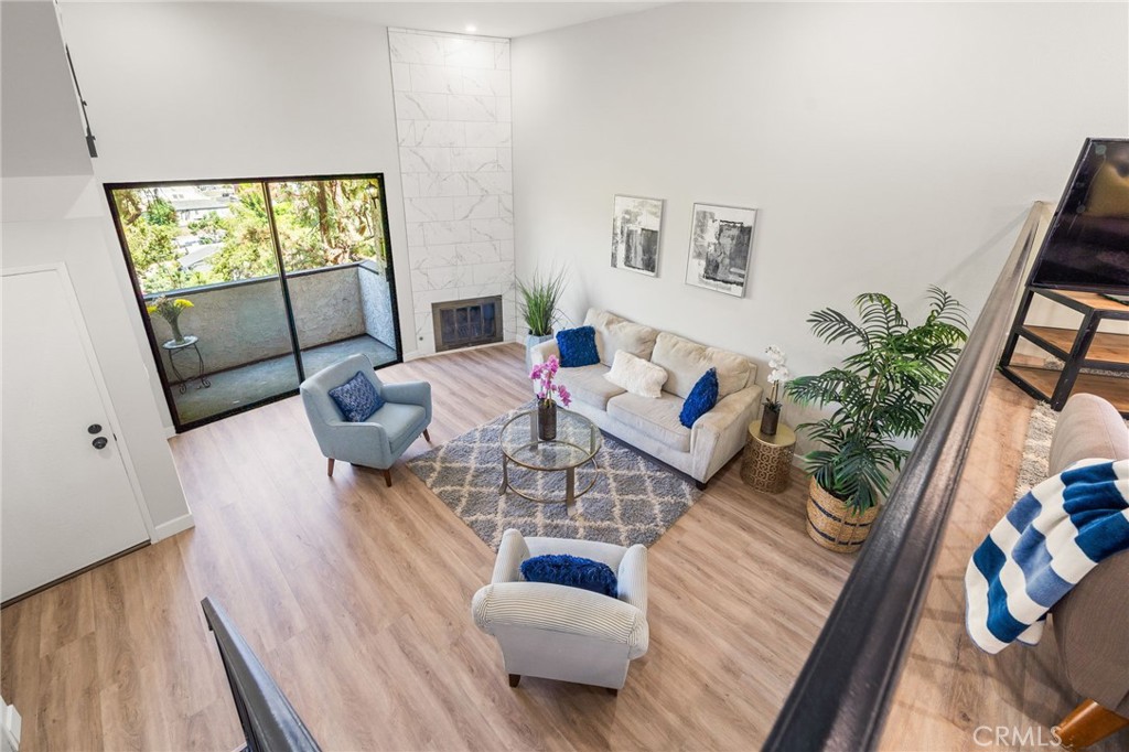 Newly and beautifully remodeled townhouse within the tranquil hilltop Oak Tree Villas community in Eagle Rock. There are 3 bedrooms, 2.5 baths, indoor laundry, and attached 2-car garage with direct access to the living room. Contemporary and move-in ready! Living room features a split-level floor plan, high ceiling with recessed lighting, gas fireplace with floor-to-ceiling tile surround, access to its private balcony, and open living and dining spaces adjacent to kitchen. Kitchen features new shaker cabinets, quartz counter tops, and stainless steel appliances. Powder room on the main floor adds convenience and is guest-friendly. Upstairs includes a spacious primary bedroom with an en-suite bathroom, two more bedrooms, and a full-sized hallway bathroom. Enjoy the mountain view and city lights through the over-sized window in the primary bedroom. Additional improvements include vinyl flooring, interior paint, lighting fixtures, and so much more! HOA amenities include a pool, spa, and outdoor sitting area with a relaxing view of nature. Conveniently located near dining, trendy shops, and top-rated schools.