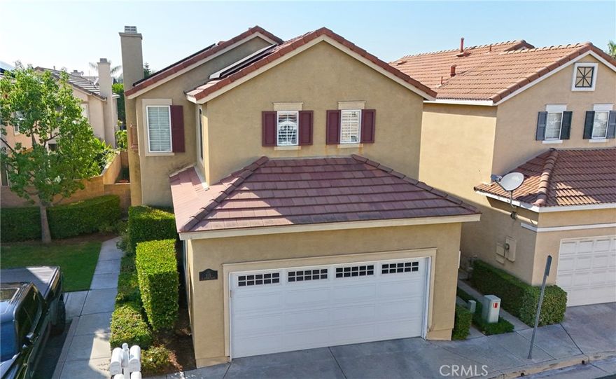 Discover a beautifully upgraded home in the prestigious gated community of Fairways at Alta Vista. This spacious 3-bedroom, 2.5-bathroom residence offers 1,750 square feet of living space with a large bonus room and a peek-a-boo golf course view. Step through a spectacular custom iron door with a glass partition panel into a world of elegance and comfort. The living room, adorned with hardwood floors, a gas fireplace with a mantle, and plantation shutters, invites you to relax and unwind. The dining room, with its chandelier and door to the backyard, offers a perfect space for entertaining guests. As you explore further, you'll find a gourmet kitchen equipped with a modern flair, including granite countertops, a subway tile backsplash, a stainless steel sink, stainless LG appliances, and an adjacent inside laundry room. The spacious bonus room, with its peek-a-boo golf course view, carpet, cathedral ceilings, ceiling fan, and plantation shutters, offers a versatile space for relaxation or entertainment. The primary suite, with its luxurious en-suite bathroom, is a true retreat. The bathroom features a dual vanity with granite countertops, tile floors, a tile shower with a mosaic inlay, a bench seat and large glass doors, and a mirrored walk- in closet. The bedroom itself boasts cathedral ceilings with a ceiling fan. Two additional bedrooms offer carpeted floors, ceiling fans, mirrored wardrobe closet doors, and custom shutters. The hallway features a built-in linen closet and a Nest thermostat. The shared hall bathroom features tile floors, a tub/shower combo with tile inlay and glass doors, granite countertops, and a new vanity and fixtures. The attached two-car garage provides ample parking and takes advantage of the Tesla solar panels. The community offers a pool, spa, playground, park, and picnic area with BBQ facilities. Recent updates, such as a full remodel in 2015-2016, a new AC unit in 2024, and a new front door in 2022, ensure this home is in pristine condition. Experience the perfect blend of luxury, comfort, and community living in this exceptional property..