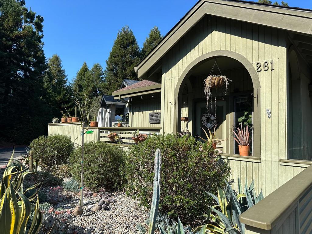 Discover coastal serenity at 261 Dry Creek, Aptos, CA 95003, a 2,050 sq. ft. gem in the tranquil Sumner Woods neighborhood. Steps from a scenic trail to Hidden Beach and Seascape Park, this 3-bedroom, 2.5-bath home blends modern comfort with natural beauty. The open reverse floor plan welcomes you with a renovated kitchen featuring granite countertops, stainless steel appliances, and new cabinetry. A scenic bay window floods the living area with light, complemented by hardwood/laminate flooring. The upper level includes a study/den, a half bath, and a spacious redwood deck, perfect for entertaining. A two-car garage offers ample storage. Downstairs, the master suite boasts a large closet and private bath, joined by two additional bedrooms for guests or home office use. Outside, a fenced enclosure with a dog run extends from the slider, while the backyard borders a lush forest, ensuring privacy and a serene escape. With modern upgrades and proximity to coastal trails, this Aptos treasure is ready to call home.