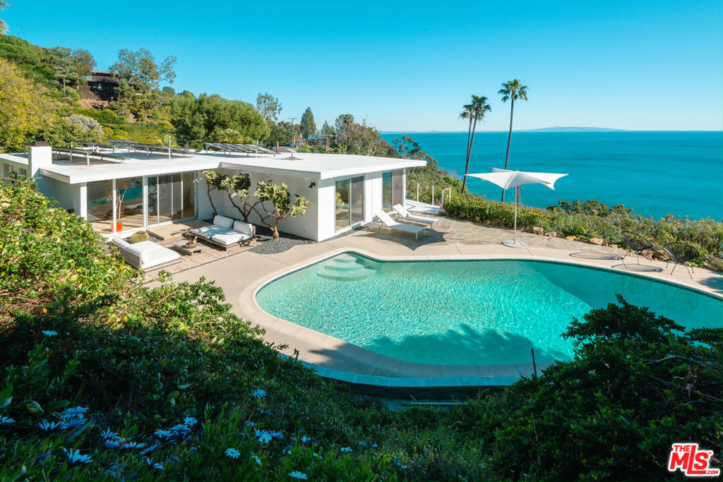 Fully furnished & ready for move-in immediately!! Experience the joy of a recently updated mid-century architecture. Complemented by drought resistant landscaping, an expansive wrap around deck, heated pool w/patio & outdoor sauna. Striking white water ocean views w/ incredible sunrise/sunsets. This single-story offers great flow between the living room, kitchen & dining area. The interior is decorated w/ modern furnishings & the entire house has hardwood flooring. Large windows throughout allow for abundance of natural light. Master on-suite w/ walk-in closet & ocean views. Spacious 2nd & 3rd bedroom feature garden view. Solar powered & carbon neutral for green living. 2 car garage. Located in the Big Rock neighborhood. 10 minute drive to Santa Monica or downtown Malibu.