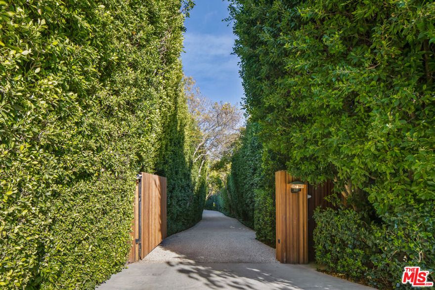 One of the most important estate properties on the westside, situated on over 3 acres with unobstructed downtown to ocean views. An incredible compound featuring 3 separate structures, which have been impeccably remodeled by one of the top design teams in the world with the highest level of quality, design, and style. The sprawling 9k sf, 5 bedrooms, 8 bath main house boasts the quintessential California lifestyle. Featuring plaster walls, gorgeous natural light wood floors, and steel doors and windows all overlooking spectacular gardens, huge lawns, outdoor kitchen, resort-like swimming pool/spa, and stunning city to ocean views. Additional amenities include a state-of-the-art Dolby Digital theater, gourmet kitchen with walk-in refrigerator, and a truly incredible owner's bedroom suite with large dual walk-in closets complete with a sunlit bathroom covered in stone with double shower steam and glam dressing area. There are also walking paths throughout the property, a basketball court and a chicken coop. There is an incredible 4-bedroom guest house with its own full kitchen and living/dining areas, plus a separate yoga/office and gym structure. Truly a once in a generation opportunity. Shown to prequalified clients only.