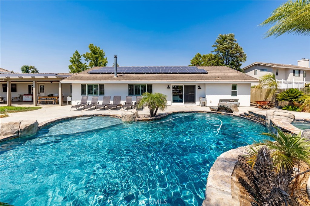Western Charm Meets Modern Comfort – A J-Bar Ranch Gem! Rare 2.46-acre double lot in Menifee’s premier J-Bar Ranch equestrian community with scenic horse trails! This single-story 4BR/2.5BA, 2,321 sqft ranch-style home with a 3-car attached garage blends modern comfort with true country living. Inside, enjoy wide-open spaces with crown molding, abundant windows, and a cozy family room with a large fireplace. The chef’s kitchen opens to the living area and features a walk-in pantry. The updated primary suite offers pool views, a walk-in shower, soaking tub, and spacious closet. Additional highlights include large bedrooms with walk-in closets, and a separate dining room perfect for gatherings.Outdoors is a true homestead retreat with a sparkling pool, spa & waterfalls, a custom saloon with upper view deck, a small moto track, and expansive patios. A massive 3,000 sqft steel drive-through building with dual roll-up doors is ideal for car enthusiasts, toys, trucks, or a workshop. Property is fully fenced with gated rear access and has plenty of room for horses, corrals, barns, RVs, or even an ADU. Practical features include leased solar, no HOA, and dual utility access. All this while being close to shopping, dining, and the 215 Freeway! And when you’re not enjoying your ranch, discover all that Menifee offers—Southern California’s largest extreme bike park, hiking and riding trails at Lake Elsinore, Diamond Valley Lake, and Historic Highway 395, plus Bell Mountain for stunning views and casual hikes. This property is more than a home—it’s a lifestyle! Schedule your private showing today!