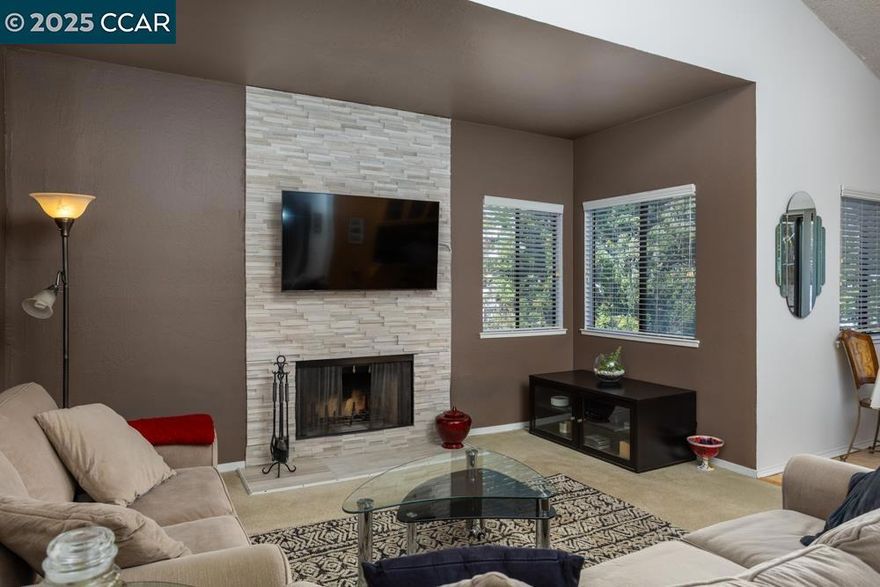 Welcome to this light and bright upper-end unit condo in the heart of Martinez! Offering 2 spacious bedrooms and 2 well-appointed bathrooms, this home is the perfect blend of comfort and style. As you enter, you’re greeted by soaring vaulted ceilings that create a sense of openness and light throughout the living space. The cozy living room features a wood-burning fireplace—ideal for relaxing evenings or entertaining guests. The kitchen is both functional and stylish, featuring a breakfast bar that opens up to the dining and living areas, making it perfect for casual dining or socializing. Bonus: Included in the sale are the washer, dryer, refrigerator, microwave, and even the stylish stools at the breakfast bar! The generous primary bedroom comes with ample closet space and its own en-suite bathroom. The second bedroom is equally spacious and can easily serve as a guest room or home office. Plus, enjoy the convenience of inside laundry and central heat and air for year-round comfort. Step outside to your private balcony, where you can unwind and take in the peaceful surroundings. As part of a well-managed community, you'll enjoy a wealth of amenities, including internet, cable, water, and garbage.A standout feature of this condo is the detached garage and an assigned parking.