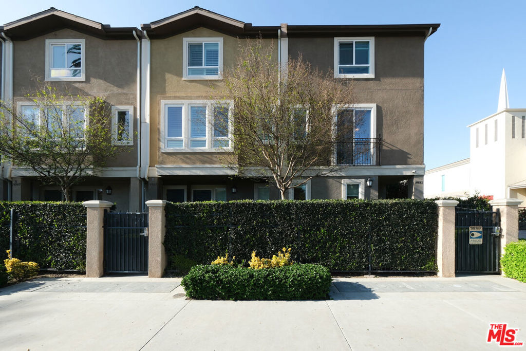 Beautiful Contemporary Townhome in Gated Azalea Community. Welcome to this bright and stylish 3-bedroom, 3-bathroom end-unit townhome, located in the highly desirable gated Azalea community. This tri-level home features abundant natural light through numerous windows and offers a functional and inviting floor plan ideal for modern living. The second level is the heart of the home, showcasing an open-concept kitchen, dining, and living area perfect for entertaining. The kitchen has stainless steel appliances, granite countertops, and ample cabinetry. Also on this level is a versatile bedroom, ideal for guests or a home office. Upstairs, you'll find two spacious primary suites, each with their own private en-suite bathrooms and generous closet space. A dedicated laundry closet with washer and dryer adds convenience, along with plenty of storage throughout. Additional features include an attached 2-car garage with smartphone access, central A/C and heating, and modern finishes throughout. Community amenities include a park, dog run, BBQ grills with picnic tables, and guest parking. Low HOA dues of only $187/month. Conveniently located near shopping centers, restaurants, grocery stores, airports, Universal Studios, and major freeways. This is a must-see home offering comfort, convenience, and style.
