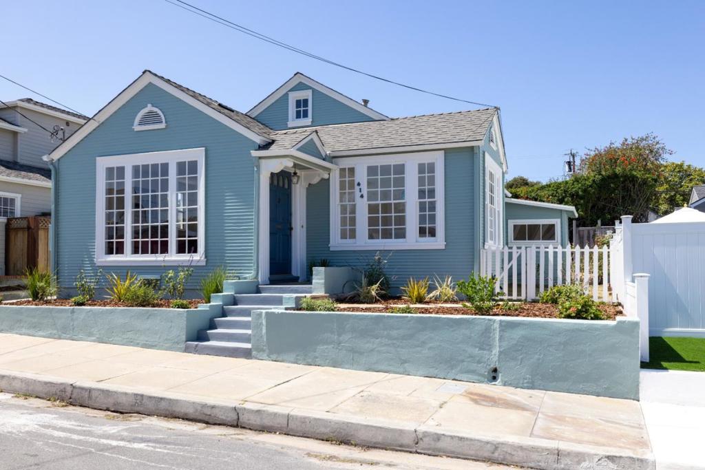 Step into the storybook charm of this enchanting Pacific Grove beach cottage, cute as a button and brimming with character. Nestled on a quaint side street with the sparkling blue bay waters just moments way, this delightful home radiates curb appeal with clapboard siding, decorative accents and inviting front porch. Inside, gleaming newly-refinished hardwood floors flow throughout, while new interior and exterior paint add a fresh and clean feel. The comfortable living room, centered around cozy brick fireplace, is a warm and welcoming space perfect for relaxing evenings or lively conversation. Framed by tall windows, the formal dining room is bathed in natural light, creating an ideal setting for morning coffee and heartfelt gatherings. Retreat to the spacious primary ensuite bedroom with full bath, offering a sense of comfort and privacy. A separate laundry room off kitchen and detached garage with storage offer practical conveniences for daily living. Outside, manicured landscaping features a flagstone walkway, fresh plantings and drip irrigation system, all enhancing the tranquil outdoor setting. Located close to pristine beaches, boutique shopping, highly-rated schools and world-class dining, this home offers the perfect blend of timeless coastal charm and everyday comfort.