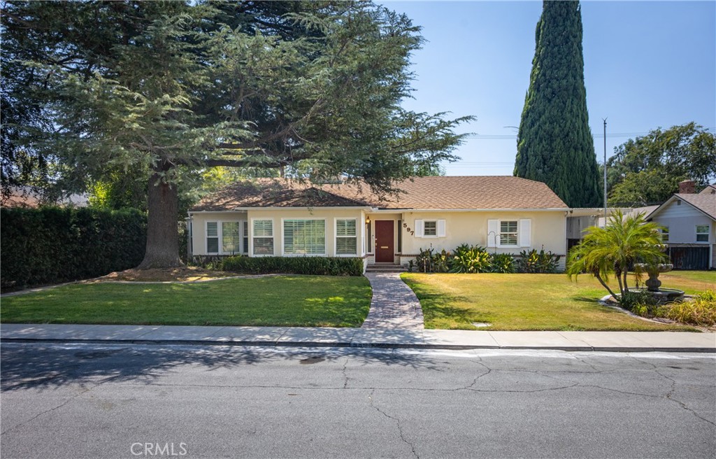 This easy flow, single-story 3 bedroom, 2 bath ranch style home was built in 1950 by the Arrowhead Country Club, boasting a rich history and classic design. As you approach the home, you are greeted by a beautiful tree in the front yard providing shade and a sense of tranquility. A large working fountain adds a touch of elegance to the front yard, creating a welcoming atmosphere. Upon entering the formal entryway, you are greeted by a spacious living room with a centered fireplace and adjoining built-in bookcases, perfect for cozying up with a good book on a chilly evening. the interior of this home was just painted and all new carpet installed. Does it have solar? YES! and paid for in full! All windows were replaced with dual pane, including the sliding glass door. In the garage, there is a SEPARATE CEDAR LINED ROOM for extra clothing storage. The formal dining room features bay windows, offering a lovely view of the front yard while enjoying a meal with family and friends. The large family room includes another fireplace and sliding doors that lead out to the rear fenced yard. Here, you will find a cement pickleball, volleyball, or basketball court with lights, perfect for outdoor entertainment and recreation.Overall, this ranch home exudes charm and character, with thoughtful details and ample space for comfortable living. Whether you are relaxing by the
fireplace or enjoying outdoor activities in the spacious yard, this home offers a perfect blend of classic elegance and modern amenities.