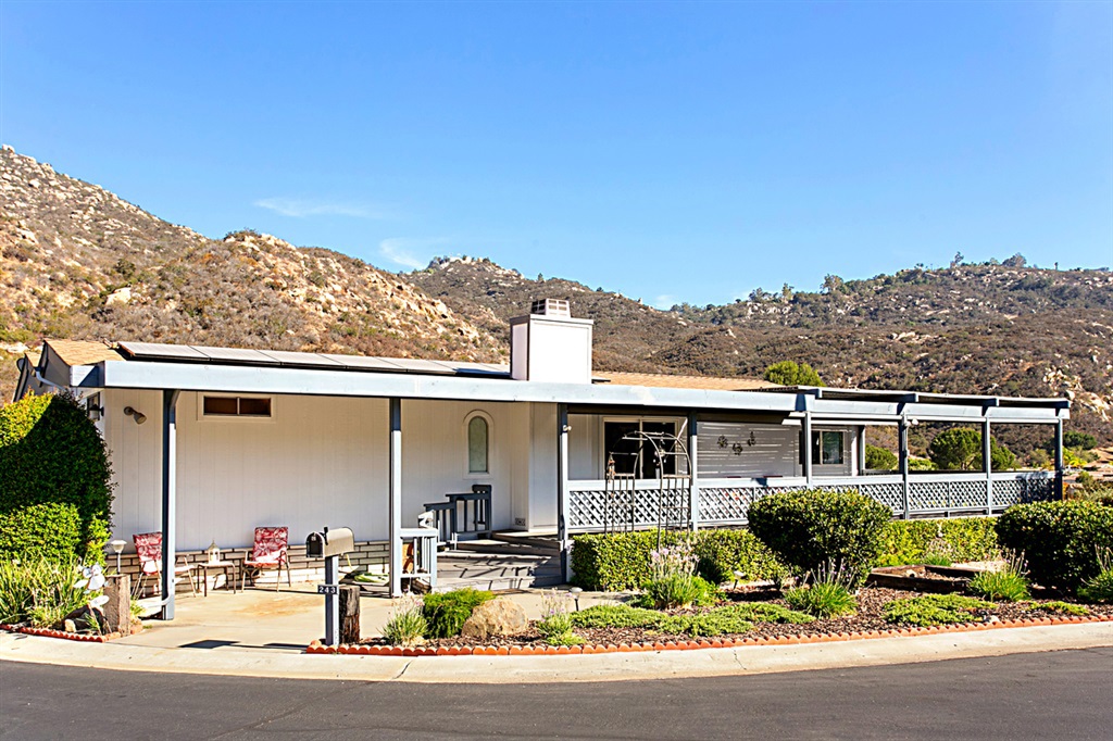 Top of the Hill, sweeping views private culdesac. Open concept floorplan with vaulted ceilings very bright and sunny. Wrap around front porch with plenty of room for entertaining. Two oversized bedrooms, Fantastic AC and with Solar panels already in place you can run it 24/7 without worry. (Current pmt $140/month goes up only 2% a year! WOW! 20 years from now it's only $200/month!) Genuine wood floors, carpet and tile. Neighborhoods: Lawrence Welk Equipment: Dryer, Washer Other Fees: 56 Sewer: Sewer Connected Topography: LL