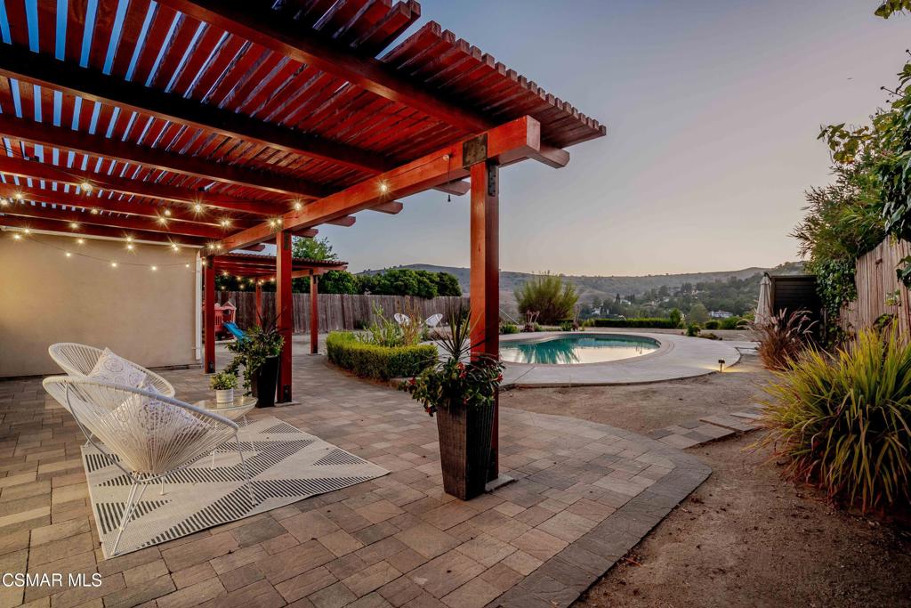 Welcome to this beautifully reimagined private, sun-drenched oasis, nestled in one of Calabasas' most sought-after neighborhoods. This sophisticated single-story home offers a bright and airy layout filled with natural light, where new wide-plank light oak hardwood floors stretch across open living spaces. The main gathering area features a sleek fireplace, stunning ''Empress Teal'' accent wall and floor-to-ceiling windows, and oversized sliding doors that invite the outside in, creating an inspiring atmosphere for relaxing or entertaining. A stylish dining space flows into a state-of-the-art kitchen complete with custom cabinetry, large center island, polished quartz countertops, high-end stainless appliances, and smart storage built for modern living. With four generously sized bedrooms with remodeled guest bath with new vanity, including a front facing primary bedroom and remodeled en suite bath. A versatile bonus room opens directly to the backyard, ideal for a home gym, creative studio, or private guest quarters. Outside, your personal paradise awaits. Cool off in the crystal-clear (recently converted) saltwater pool, unwind under a strikingly beautiful redwood cover, or host unforgettable evenings on the expansive patio. Panoramic views of the surrounding mountains provide a stunning daily backdrop, giving you the feeling of living in European hillsides. The home also boasts a premium NEM2 solar system, ready to keep energy bills nearly nonexistent. Recent updates include a brand-new roof (2023 w/10 yr warranty), upgraded 200-amp electrical panel with extra circuit, EV charger, new hardwood floors including leveling of the floors, installed recessed lighting throughout, new HVAC ductwork, new drip system, new linen closet in hallway, 2 guest rooms with California Closet organizers and storage, new closet doors in 1 guest room to triple rack. Ideally located just minutes from acclaimed Las Virgenes schools, hiking trails, boutique shopping, fabulous restaurants, convenience of the 101 freeway, and the legendary beaches of Malibu, this turnkey property delivers the ultimate Calabasas lifestyle. Elegant, efficient, and effortlessly connected to everything that matters.