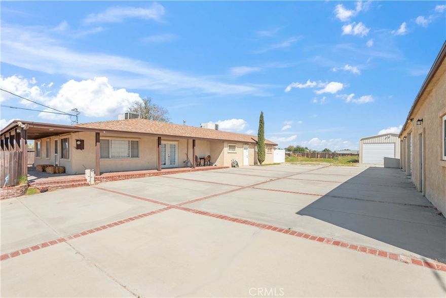 This is a highly versatile property offering opportunities for multi-generational living, income potential, storage, or a live/work setup. With its multiple structures and large usable lot, it’s perfect for investors, contractors, or anyone seeking extra space and flexibility. 1 acre lot featuring main house with 3 bedrooms, 2 bathrooms, a spacious primary bedroom, and a dedicated laundry room. The second detached structure includes a large 3-car garage and a bonus room/2nd unit. Also included is an approx. 50' x 24' metal building with oversized double doors—perfect for a shop, storage, or home business. Property includes 2 electric meters (one for the main house and one for the second structure), 2 septic tanks, and an electric gate.. A truly flexible property with room to grow!