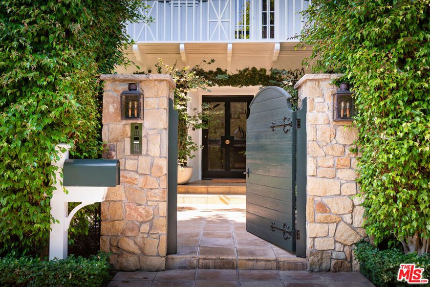 Extremely private at the end of the cul-de-sac on prestigious Perugia Way with extraordinary West facing views above the Bel Air Country Club.  This 1932 Monterey Colonial has been remodeled with care to modernize and update while retaining the charm of a different era.  Location, seclusion, views and old-world architecture that remains true to the past.  A rare find.