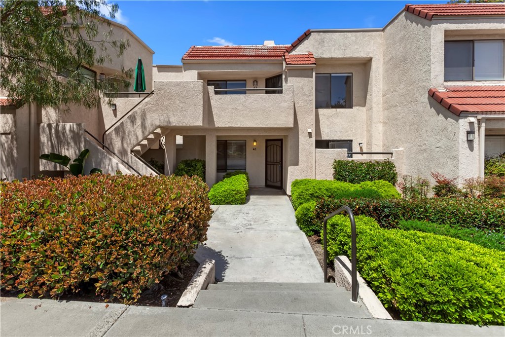 Beautifully maintained unit in Crystal Cay Community, part of Laguna Heights. This spacious upstairs single level, 2 bedroom, 2 Bath condo with a storage room in the gated front porch. Entertain from this open floor plan with updated kitchen open to the living/dining room. This open and bright unit boasts cathedral ceilings, skylight & ceiling fan. Enjoy rich wood laminate flooring, tile fireplace with mantle & gas fire logs. The master bedroom includes a private tub/bath, secondary bedroom the bath is just off the hall, along with the laundry closet with newer stack washer/dryer. Refrigerator is also included. The carport is within the building, fully covered with a storage area overhead. Crystal Cay Community has 2 pools/2 spas and is well located near schools, shopping, hiking & biking trails, beaches & freeways! New carpet in both bedrooms.
