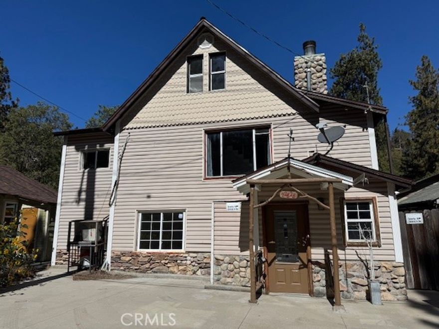 Enjoy the serenity of life in the Valley of Enchantment.  Generous parking for three cars out front. The main level entry impresses with beautiful beamed ceilings and inviting fireplace.  There are bedrooms upstairs and a potential master bedroom downstairs or you can divide lower level to make extra income. A huge (14x30) deck in the back yard allows enjoying beautiful views in comfort and safety.  If four bedrooms isn't enough space to put all your stuff, there are two sheds out back. Buyer to confirm measurements, features, and usability of all facets of this property.
