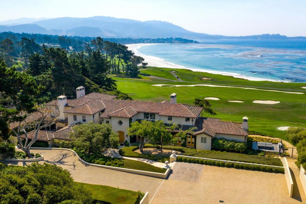 Rarely does a property become available in Pebble Beach that truly distinguishes itself from the rest. Situated on the coveted 13th fairway of the Pebble Beach Golf Links with panoramic views of the ocean and golf course from Carmel Beach to the 6th and 8th holes. This 6 bedroom, 6 full, 2 half bath contemporary Mediterranean masterpiece presents a sophisticated, clean elegance and the highest level of craftsmanship and quality. The many amenities include: 2 master suites, the ultimate chef's kitchen, elegant cigar-friendly office, billiard room with bar, wine room, exercise room, home theater, golf simulation room, greenhouse, putting green and chipping area and wonderful indoor/outdoor living with two great patios, one ocean-side with fire-pit and the second interior sheltered from weather. No expense was spared in building a truly priceless home designed for both intimate and large gatherings. From the minute you enter the gates of this magical property, you have found nirvana.