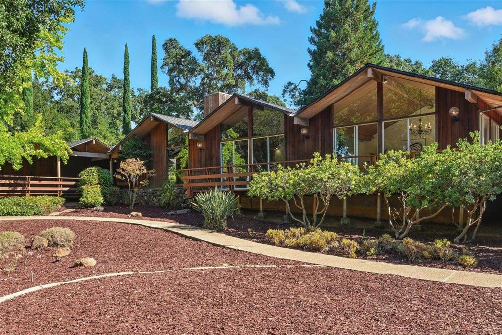A rare opportunity to own a timeless Saratoga Mid-Century Modern estate in one of the most prestigious neighborhoods. Privately tucked behind a gated entrance on a flat 1.24-acre lot, this 5-bedroom, 3.5-bath, 5,323 sq. ft. single-level residence offers architectural pedigree, thoughtful updates and serene privacy. Originally designed by award-winning architect Warren Heid with remarkable attention to detail & symmetry, the home was envisioned as a Japanese garden inspired retreat, blending Wabi-Sabi simplicity with modern minimalism. Open floor plan showcases soaring vaulted ceilings & dramatic walls of glass, creating a seamless connection to the sun-filled landscape w/ majestic oaks & redwoods. Numerous skylights bathe the interiors in abundant natural light. Separate spacious living and family rooms, a formal dining room, and a gourmet kitchen with sleek counters & top-of-the-line appliances. The luxurious master suite features glass doors that open to the lush backyard. Recent updates include a brand-new roof, new hardwood floors, a crafted deck, .etc. Walking distance to Saratoga Elementary and charming Downtown Saratoga. Just minutes to Villa Montalvo and the Mountain Winery. Highly acclaimed Saratoga School District! This property is truly an extraordinary offering!