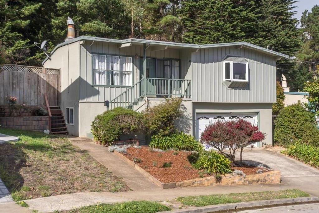 Come to the coast and live in a desired neighborhood across from the Pacific Ocean and hiking trails. Some updates include major kitchen remodel with granite countertops, breakfast bar, desk area, garden type window, and pantry plus abundance of cabinets. Original oak wood floors throughout, corner fireplace, and cathedral beamed ceiling is typical of the mid century design. Nice wood deck and cement paver patio in rear yard. Potential accessory dwelling downstairs off two car garage. Additional room for workshop area. Great location for commuters; near bus, close to Bart and SF airport. Come cruise along the coastal highway and enjoy a day at the beach surfing, fishing, standup paddle board or a round of golf.