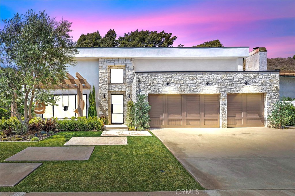 Live Where the Trail Meets the Sea. Rebuilt Luxury Pool Home Near Dana Point Harbor. Completely rebuilt in 2023, this like-new luxury pool home in Meredith Canyon offers an elevated coastal lifestyle just minutes from Doheny Beach, Baby Beach, and Dana Point Harbor. Nestled on a quiet, private street with ocean views at one end and lush hiking trails at the other, this spacious 5-bedroom, 4-bath home seamlessly blends thoughtful design, modern comfort, and indoor-outdoor living. Everything new in 2023, including: roof, windows, plumbing, HVAC, electrical, CAT-6 wiring, security system, electric car outlet and full smart home automation —offering peace of mind and next-level efficiency. The Sonoma White Limestone exterior and custom Pinky’s steel and glass door make a bold statement as you step inside to soaring 20-foot vaulted ceilings, a light-filled great room, real hardwood floors, and a striking modern fireplace. The designer kitchen is built for both everyday living and entertaining, with Euro-style cabinetry, quartz countertops, Thermador appliances, and a Thor 6-burner range built into a showstopping island. A secondary prep kitchen and multiple dining areas make hosting effortless. The flexible layout includes a full downstairs bedroom and bath, with four additional bedrooms upstairs—one with an en-suite—plus a stunning primary suite with custom paneling, a spa-like bath with soaking tub and oversized shower, and a spacious walk-in closet. Step outside to a private backyard retreat with a beautifully redone saltwater pool, fire pit, Viking BBQ, and outdoor bar framed by mature olive and magnolia trees. Just down the street, a scenic hiking trail comes alive with wildflowers in season, and a sprawling community soccer field sits at the base of the neighborhood. With world-class beaches, harbor access, and a vibrant strip of restaurants and shops minutes away, this home offers the best of luxury, location, and lifestyle in one of South Orange County’s most desirable communities.
