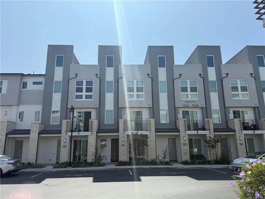 Discover modern luxury and comfort in this upgraded 4-bedroom, 3.5-bath townhome located in the private, gated 100 West community by Toll Brothers. Tucked away from the main road, this quiet end-unit features 1,913 sqft of stylish living space, a two-car garage, and a stunning rooftop deck with panoramic city views and Disneyland fireworks. The first floor offers a private guest suite, ideal for visitors or a home office. The main level boasts an open-concept layout with a chef’s kitchen, quartz countertops, premium appliances, and two balconies. Upstairs, the primary suite includes a spa-like bathroom and walk-in closet, along with two additional bedrooms and a laundry room. The rooftop deck is perfect for entertaining or relaxing under the stars. Located in Anaheim’s Platinum Triangle, just minutes from Disneyland, Angel Stadium, top universities, and major freeways.