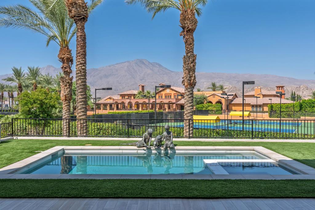 Step into effortless sophistication with this impeccably crafted 3-bedroom, 3.5-bath Villa in Andalusia Country Club, prominently positioned on a premium lot just a short stroll from the clubhouse. Capturing sweeping 180-degree views of the Santa Rosa and Coral Mountains, this 2,634 sq ft home is designed for those who value comfort, style, and harmonious indoor-outdoor living. A private detached casita with its own entrance offers ideal accommodations for guests. Inside, clean architectural lines and natural light define the open-concept layout, while expansive glass pocket doors open to a covered loggia that invites alfresco dining and relaxed lounging. The gourmet kitchen is both functional and refined, appointed with sleek cabinetry, top-of-the-line appliances, and a generous island for casual entertaining. The primary suite offers a tranquil sanctuary with dramatic mountain views, an elegant spa-style bath, and a spacious walk-in closet. Outside, a resort-style pool and spa create a private escape, perfect for soaking in the beauty of the desert landscape. An owned solar system adds efficiency to this thoughtfully curated home. Come live the life you've always imagined!