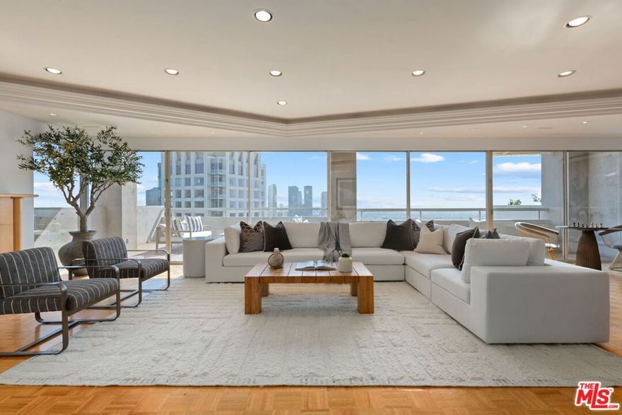 Once in a great while does an expansive Penthouse such as this become available on Los Angeles' famed Wilshire Corridor. Now for sale for the first time in over forty years, this very special condominium home offers an unusual amount of elegant, sun-bathed space with dazzling forever views from most every room. The wide and welcoming formal foyer is ideal for showcasing art. In the north wing, find a very spacious, well-planned kitchen with a butler's pantry and a sweet breakfast area. Adjacent is the large formal dining room with seating for twelve and access to the northern terrace, with its serene views of the Los Angeles Country Club greens, its views of the wooded mountains and hills and its views of the beautiful Bel-Air and Holmby Hills residential neighborhoods to the north. There's also an open family room in this wing, perfect as an office or as a casual TV room. The south wing features a vast living room complete with a decorative fireplace and a very pub-like, sit-down bar. The large southern terrace is accessed here and is the perfect spot for lounging comfortably while taking in the dramatic, sparkling city lights vistas stretching all the way to the ocean. This wing also features a second kitchen and a laundry area. The primary suite is enormous and private with its own sitting room, its dual baths and its dual closets. Equally private is the ensuite guest bedroom. Two guest powder baths and an abundance of storage space complete this fabulous floor plan. Since this home is the product of having combined two units many years ago, there is flexibility in the floorplan should one wish to potentially capture additional bedrooms or make other changes. The very central location is quite proximal to UCLA and to Beverly Hills, Westwood, Century City and Brentwood and all the fine shopping and dining each area affords. Coveted inclusion in the Warner Avenue Elementary School district. The Wilshire- Comstock is a well-regarded, full-service building with around-the-clock doormen. Its location is extra special since ingress and egress is on quieter Comstock Avenue versus on busy Wilshire Boulevard. Please see listing sheet for a full roster of amenities.