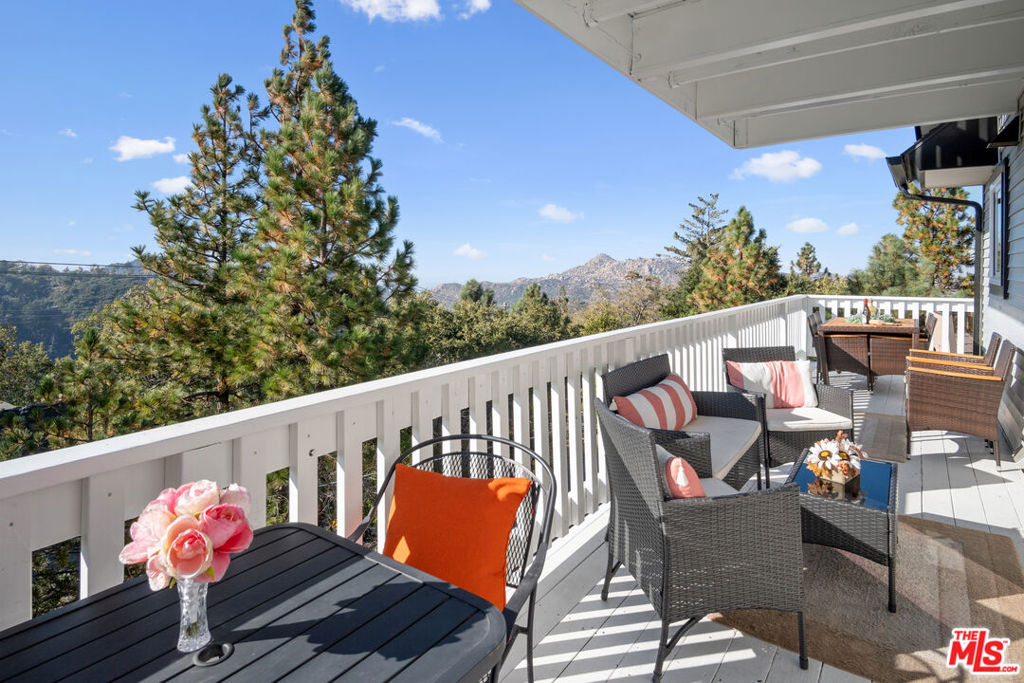 Fully Furnished Turn-Key Airbnb Lake Arrowhead Home! Welcome to your exclusive mountain entertainer's lake and golf retreat where luxury meets nature in the serene Lake Arrowhead Woods community of Grass Valley! Nestled in between the main lake and Country Club with Lake Rights. The spacious Tri-level home has 4 bedrooms, 4 bathrooms, an expansive game room, and an upstairs loft/Poker room. This home offers an unparalleled blend of comfort and elegance. As you enter, be greeted by the rustic charm of an open inviting interior, accentuated by high wood beam ceilings, cedar wood panels, gorgeous mountain-stye rustic flooring, a wood burning fireplace that extends all the way up the rustic stone wall adding character and warmth to this serene home. Indulge your senses in the entertainer's kitchen, with sleek Calacatta Lux countertops, complete with stainless steel appliances, and ample cabinet space, perfect for culinary enthusiasts or casual meals with family and friends. Relax in your Primary Suite Retreat on the main floor. The additional Family Suite downstairs offers a separate entrance, private bathrooms, and a laundry room and it could easily become the perfect In-Law Suite. The large wrap-around deck offers panoramic views of the surrounding mountains and vistas of the fairways, while the serene backyard surrounded by fruit trees and enclosed by a fence, invites you to unwind in the natural mountain splendor while gathering with the family and grilling under the stars. This home has dual access and two private driveways offering ample parking, and space for a boat or jet skis. Located just minutes from the Beach, Tavern Bay Beach Club, shopping, golfing, tennis, pickleball, Country Club, lakes, mountain museum, hiking trails, and restaurants. You'll have easy access to all Lake Arrowhead has to offer and more! This exclusive retreat is perfect for hosting events, gatherings, celebrations, holidays, remote work, golfing, swimming, and much more, making it an ideal choice for those looking for both relaxation and entertainment. Plus, take advantage of its transferable STR permits and current Management offering an Airbnb-ready home and immediate potential income opportunities. Get ready to embark on your mountain retreat adventure in style! Schedule a showing today and experience the finest in mountain living firsthand!