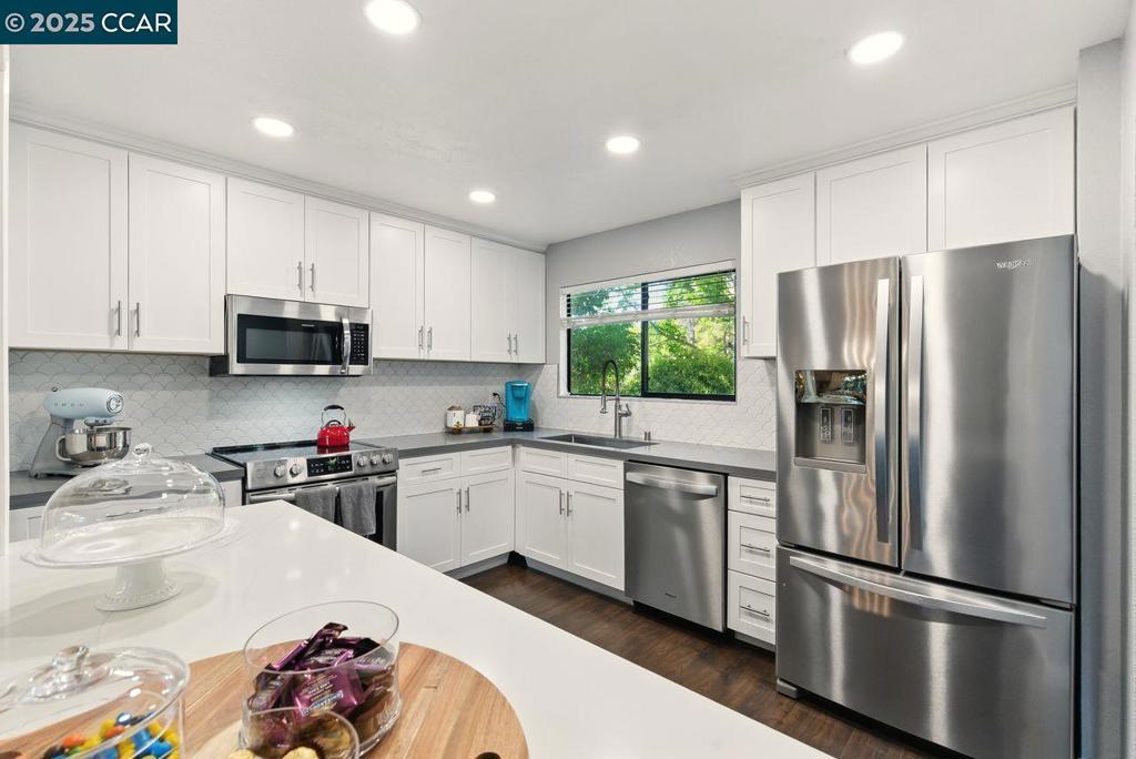 Refined Living Meets Nature in This Modernized Townhome. Where comfort, style, and natural beauty come together, this updated 3-bedroom, 2.5-bath corner townhome offers approx. 1,725 sq. ft. of thoughtfully designed living space. Nestled among majestic redwoods, it features an open-concept layout with an inclusive and inviting feel, vaulted ceilings, a cozy gas fireplace, and a glass door leading to a private wood deck - perfect for enjoying the serene setting. The remodeled kitchen includes modern quartz surfaces, stainless steel appliances and a seamless connection to the dining and living areas - ideal for both daily living and entertaining. Upstairs, the primary suite offers a walk-in closet and updated en-suite bath with a sleek shower. A second full bath features a soaking tub, and the main-level powder room adds charm with a wood accent wall. Extras include in-unit laundry, an attached two-car garage with shelving, and access to a community pool and tennis courts. The $485/mo HOA fee covers the roof, exterior maintenance, and more. Conveniently located near highways, shopping, and dining. ASK about the special *Lender interest rate BUY-DOWN* - schedule your private showing today!
