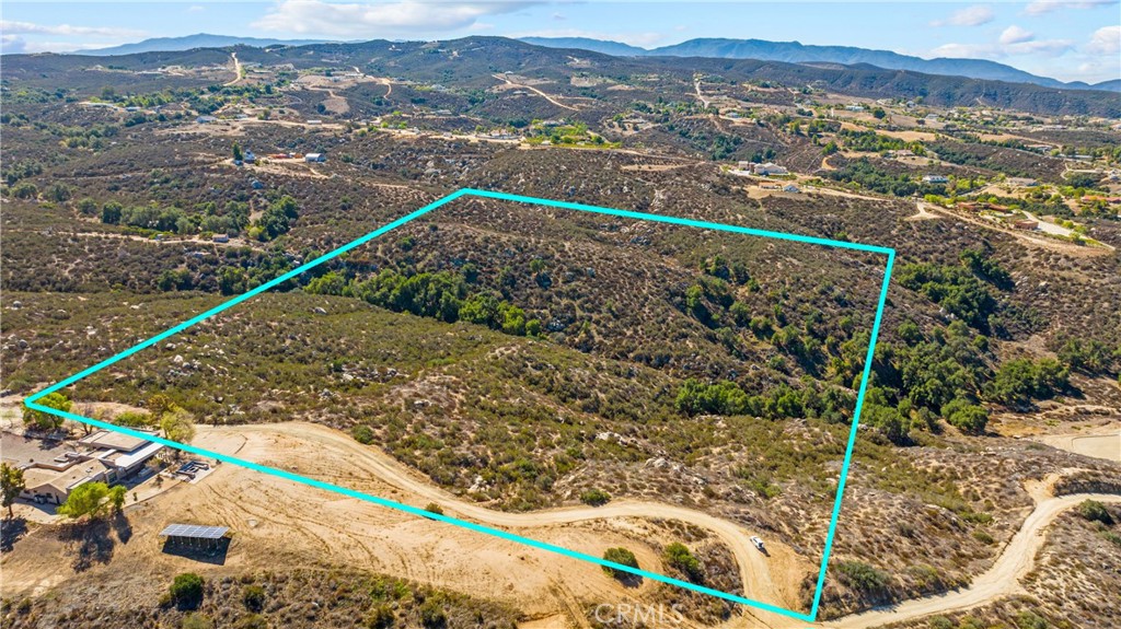 TWENTY ACRES in the hills near De Portola Road/ Glen Oaks community, wine country, Temecula. The northwest corner is marked where Calle Breve and Calle Azure meet. Forever views over the Temecula Valley and up toward the Santa Ana Mountains. There is approximately 669 feet of frontage on Calle Azure, where you can choose to bring in a driveway and switch back until you reach a naturally level area, perfect for a custom homesite, nestled in, but not obscuring yourself from those incredible vistas. Terrace your sprawling acreage down around magnificent boulder formations and down toward a natural waterway and stands of evergreen California Live Oaks. This gentle slope is ideal for grape vineyards, according to local farmers and winemakers. However, the Mediterranean climate is also suitable for a variety of other crops, such as olive or fruit orchards, nut trees, lavender, and other herbs, as well as flowers and other botanicals. YOU will grow better here, too, under unpolluted, gorgeous night skies, with clean air, and the space to really breathe. Surrounded by neighboring new and custom construction - but not too close - ensures an investment sure to repay its new steward in spirit and wholeness and value, for years to come.