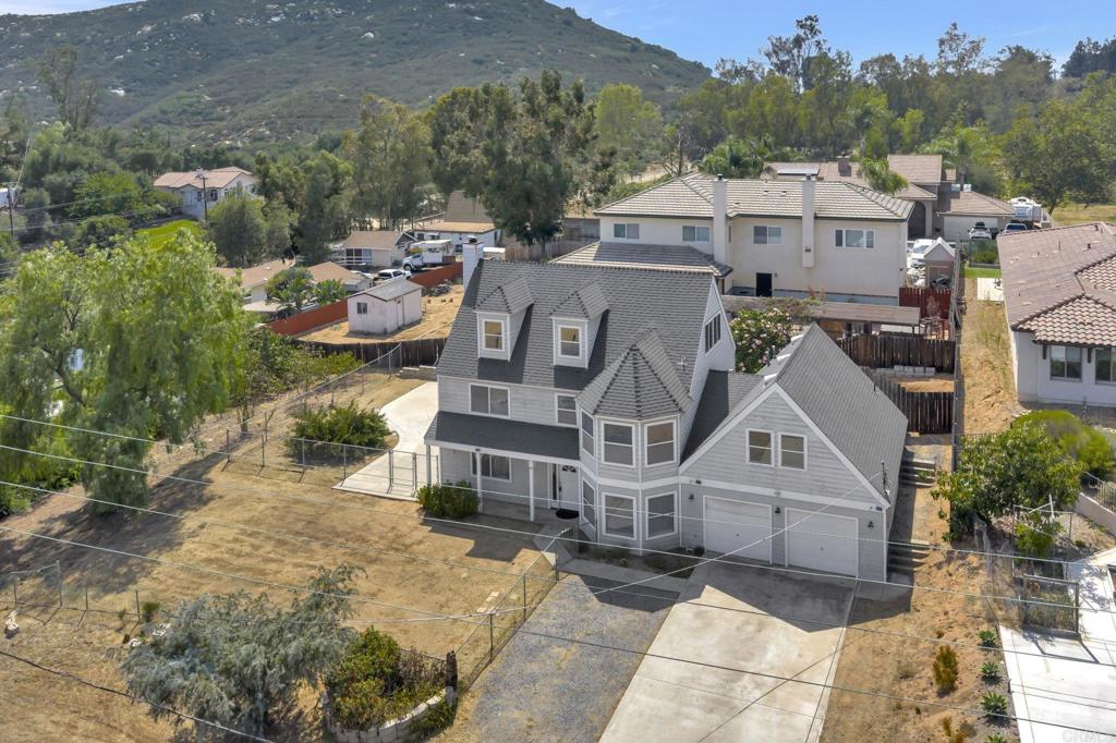 The DEAL you've been Waiting for! This Spacious Custom-Built Estate in Crest comes complete with multi-family living space or an income producing ADU rental!!! Boasting over 2,600 square feet, this Craftsman Style Beauty sits on over a third of an acre of land, mostly flat with plenty of parking and room for more. Stunning Views from all second-floor bedrooms. Enjoy an open floor plan with abundant natural light in this 3 bedroom, 3 bathroom home, including an Office/Family Room, an Oversized Living Room with a Large Brick Fireplace & Picture Windows allowing view to the beautiful outdoors! There is an unfinished 3rd floor that could be converted to additional sq footage and bedrooms. The 2-car garage includes space for the washer and dryer and plenty of room for parking. Step outside to a private backyard oasis—ideal for entertaining or relaxing in the California sunshine. Plenty of room for a play area, perfect for family fun and entertaining. Don’t miss the major Bonus is the attached ADU above the garage, previously rented for $2,200/month and left in excellent condition—ideal for extra income or guest accommodations. The Opportunities for this property are ENDLESS. The home is quietly tucked back into the highly sought after Crest neighborhood in El Cajon, yet close enough to major freeways to make your commute a breeze. Mature Fruit Trees include Avocado & Citrus. Completely fenced Property with a Driveway allowing Easy Access & Parking for all your Entertaining! Cosmetic updating needed so bring your imagination and earn some instant equity! There's plenty of room for horses and big toys, making it an ideal space for outdoor enthusiasts. Located close to local schools, parks, shopping, and dining, this home combines suburban tranquility with urban accessibility.
