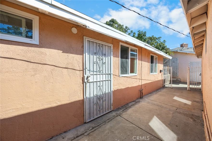 This detached 2-bedroom, 1-bathroom duplex offers a comfortable and practical living space. The unit was remodeled within the past year and features durable vinyl flooring and a clean, simple layout. The kitchen includes a gas stove and microwave, and the home stays comfortable year-round with an in-wall A/C and heater combo. Outside, tenants can enjoy a small private patio with tile flooring—a nice spot to relax or have a quiet meal outdoors. The unit includes two parking spaces in a carport, fitting two small to medium cars or one larger vehicle, with extra street parking available. Water and trash are paid by the property owner. No pets or smoking allowed.