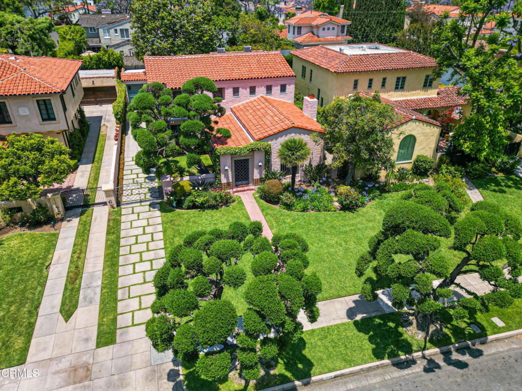 Step into the timeless elegance of this exquisitely restored 1931 Spanish Revival home, nestled on one of the most desirable streets in the Mission District of San Marino. Lovingly restored by its current owners, only the third stewards of this exceptional property, every inch has been thoughtfully updated to honor its rich architectural heritage while embracing the needs of modern living. With 4 spacious bedrooms, 3 bathrooms, and a dedicated office, the home's versatile floor plan is ideal for everyday comfort and entertaining. Beyond the striking curb appeal lies a charming enclosed courtyard. Enter through a gracious foyer adorned with a meticulously restored magnesite entry and staircase, setting the tone for the artistry and craftsmanship found throughout. The dramatic living room features soaring beamed ceilings, an original fireplace, and a stunning picture window framed by intricate wrought iron, offering views of the front courtyard. Adjacent, the office is a sanctuary of its own, with custom built-in bookcases and chapel-inspired doors. Host in style in the formal dining room beneath a hand-stenciled ceiling and an original wrought iron chandelier. The breakfast room, drenched in natural light, has French doors that open to the backyard. The kitchen is a chef's dream, beautifully updated with stone countertops, tile backsplash, double ovens, gas cooktop, cocktail sink, and abundant storage. Hidden laundry cabinets offer added convenience. Downstairs, a guest bedroom and an adjacent vintage-tiled bath offer privacy and charm. Upstairs, you'll find 3 additional bedrooms and 2 full baths, including a luxurious primary suite complete with a dressing room and private balcony. The show-stopping 2024-renovated primary bathroom features a rare Gladding McBean swan tile mural, a porcelain cast iron tub, stall shower, and period-inspired jade green pedestal sink and toilet. This home has been meticulously updated over the past two decades, including new HVAC (2022), new roof (2023), refinished hardwood floors, rebuilt deck, mostly copper plumbing, and replica custom windows. Most of the original light fixtures and hardware remain intact, many showcasing exquisite Art Deco details. A California basement, detached 2-car garage, and a private backyard with tall hedges and a mature magnolia tree complete the package. This property is a rare architectural find in a quiet neighborhood.