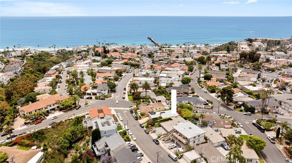 Hidden away on one of south San Clemente’s hardly-traveled streets, this canyon-adjacent duplex offers amazing optionality and a lifestyle unmatched. Located right on the border where the central San Clemente zone meets prime Southwest (a premiere pocket on the south side of Avenida Del Mar), this beachy duplex is really rare to come by in such an exceptional location. About a 10-minute walk from the front door to locals’ favorite sandy T-Street beach or straight down Cazador Ln to the SC pier and restaurants, or an easy walk right over to the main street at Avenida Del Mar (less than half a mile to all). Walkability to all the area has to offer is key to this property. Upon arrival, the structure appears as a beachy single family residence but offers two single-level units attached by one wall. Each unit is made up of one generous bedroom, one updated bathroom, one garage, a galley kitchen just off the cozy living room with a gas fireplace, & separate outdoor living areas unique to each side. Each unit offers their unique perks with slightly different floor plans & arrangements. The unit on the right was recently updated throughout with new LVP flooring, vinyl windows, ceiling fans, wired speakers, recessed lighting, window treatments, dutch door, quartz hearth, shaker doors & hardware, updated kitchen with stainless appliances, quartz counters, cabinets, backsplash, & fixtures. A newly-updated bathroom with shiplap, tile & fixtures services the unit. Newer French doors lead outside to a redone lounging / dining patio with a large built-in gas fire pit, built-in surround seating, & mature landscaping. The unit to the left offers front-loaded outdoor living with a gated entry courtyard & patio. This area is very private. Updated within the last 10 years on this side including windows, recessed lighting, window treatments, polished concrete floors, fixtures, & doors. An updated kitchen with stainless appliances, quartz counters, cabinets, backsplash, & fixtures compliments the updated bathroom with subway tile, granite counters & fixtures. More space in the back creates opportunity for another private patio or private yard (currently unimproved). Walk out your front door(s) to the beach & play volleyball at the public courts nearby, take the 2.5 mile beach trail to many newer cafes, bars, ocean-view restaurants, & the iconic SC Pier. Glassy morning beach break surfing just out front or a quick & fun bike ride to world-class surf at Trestles.