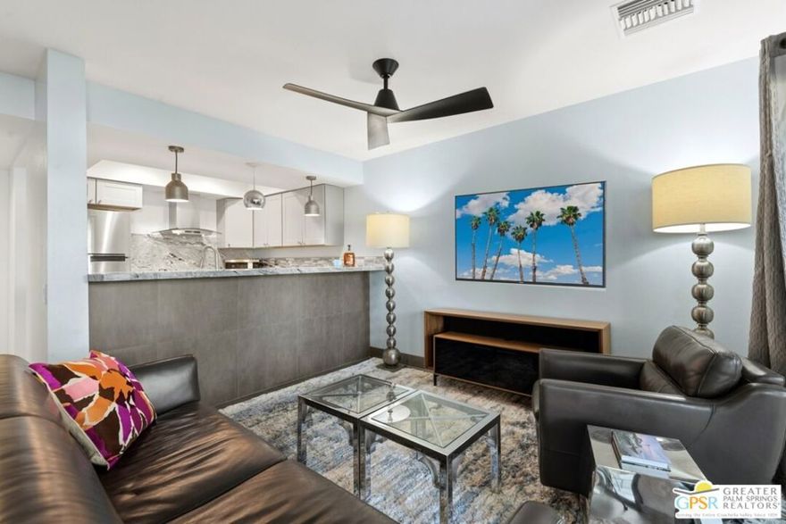 Welcome to this beautifully renovated 1-bedroom, 1-bath ground-floor condo at the highly desirable Riviera Gardens! This end unit is just steps from one of the community's sparkling pools and spas, with convenient covered carport parking nearby. The home has been completely transformed with a comprehensive remodel - the original accordion doors between dining and bedroom were replaced with a proper wall, creating true separation and a dedicated dining space with better privacy and flow. The kitchen features all new stainless steel appliances including dishwasher, microwave, range/oven, and refrigerator, and has been intelligently reconfigured for improved walk-through access. Updated throughout with tile flooring, updated bathroom, expanded bedroom closet, and a walk-in laundry area housing stackable washer/dryer. The living area opens to a private covered patio with green belt views, perfect for relaxing. This gated, resort-style community sits on fee-simple land you own (no land lease!) and offers lush mature landscaping, multiple heated pools and spas, and controlled access.  Located minutes from uptown and downtown Palm Springs dining, shopping, and entertainment, yet tucked away in a peaceful setting. Ground-floor convenience, end-unit location, pool-adjacent positioning, and complete updates make this perfect as a primary residence, vacation getaway, or investment property. Move-in ready and waiting for you!