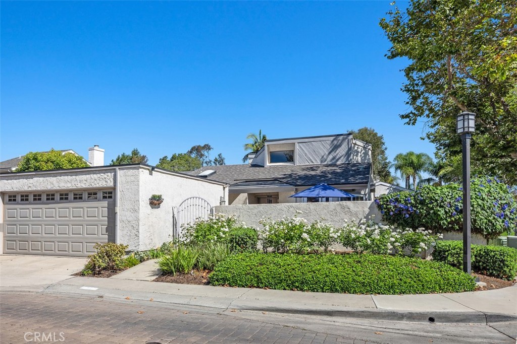 Welcome to Your Dream Home! Imagine waking up in a beautiful, single-story home with plenty of natural sunlight and fresh air pouring in through the skylight window in your primary bedroom. The gated front entry is perfect for added security and a touch of elegance. The 2-car garage with a door leading to the front porch provide ample parking and storage space. The heart of the home is the stunning living room, complete with a dual fireplace that flows seamlessly into a cozy den/library. The perfect spot to curl up with a good book or enjoy quality time with loved ones. The adjacent dining room is ideal for hosting dinner parties, and the breakfast nook in the kitchen is filled with natural light pouring in through the French door that leads out to the enclosed front patio. The primary bedroom is a serene oasis, complete with an upgraded bath featuring dual sinks, a walk-in closet, and a long wardrobe closet. The beautifully upgraded secondary bath boasts a walk-in shower, and the laundry room is conveniently separated by a stylish barn door. This fantastic home is situated on a front corner lot of a quiet cul-de-sac street, providing a peaceful and private living experience. With high ceilings, upper windows, shutters, French doors, plenty of windows, and wrap around yard featuring lemon and cumquat trees, this home is light, bright, and airy - the perfect haven to call your own. Located in the highly desirable community of Lake Park. Come make this incredible property your home!