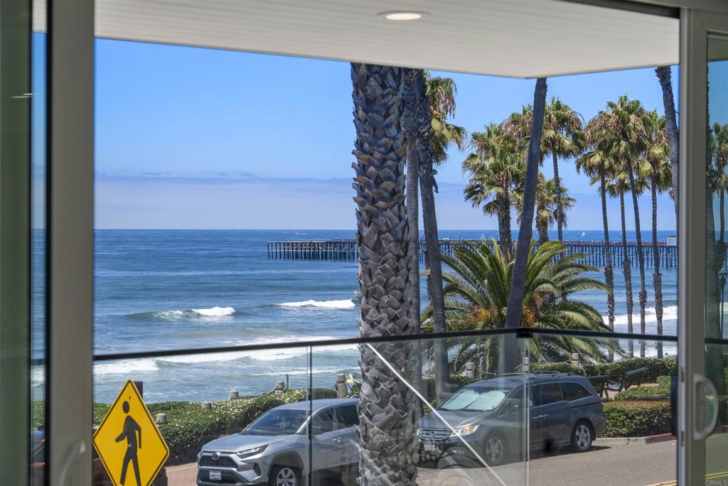 Panoramic white-water views set the stage at this brand-new modern beach home on Oceanside’s iconic Pacific Street. Just steps from the sand, this is one of two newly completed residences in a striking duplex—each with its own utilities and legal parcel number. Don’t miss the rare opportunity to purchase one or both homes and own the entire building, offering the flexibility for investment or multigenerational living (Other address is 214 S Pacific St MLS # NDP2507465). This 4-bedroom + bonus room/office, 2.5-bath home offers 2,600 sq ft of light-filled space with clean modern finishes throughout. The open-concept main living area flows directly to a spacious ocean-facing deck—perfect for dining al fresco, watching surfers skim the waves, and taking in the unforgettable sunsets. The oversized primary suite includes a retreat area, walk-in closet, and private balcony. Additional highlights include a 1-car garage plus tandem covered parking, ductless A/C throughout, and a west facing ground level patio, with ocean views of course! Enjoy effortless access to the beach right across the street, bring your surfboards and boogie boards! Ideally located just two blocks to the Oceanside Pier and within walking distance to the city's best restaurants, rooftop bars, cafes, and the weekly farmers market. With prime beach access and short-term rental potential, this property offers both an exceptional lifestyle and investment opportunity. Own a piece of the coast on one of Southern California’s most desirable beachside streets.