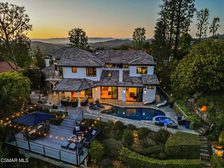 With commanding, panoramic south-facing views that stretch across the rugged expanse of the Santa Monica Mountains and down into the serene folds of Triunfo Creek, every glance south is a masterpiece of nature. This exquisite 4-bedroom, 3.5-bathroom home plus office underwent a full-scale remodel down to the studs in October 2020, seamlessly blending modern luxury with timeless design. Every detail has been thoughtfully considered--from the newer high-voltage electrical and plumbing systems to the Control4 smart home integration inside and out. Refinished maple wood floors run throughout, complemented by custom wood doors, seamless molding, and newer windows that flood the space with natural light.  The chef's kitchen is a showstopper with top-of-the-line Miele appliances, a steam and speed oven, and a striking quartz island with raised butcher block bar seating. A lighted wine display backed with quartz anchors the custom bar area, with dual built-in wine refrigerators (accommodating 350 bottles). The primary suite is a true retreat, boasting a raised tongue & groove ceiling, dry sauna, soaking tub with mountain views, a supersized walk-in closet, shower and radiant heated floors. Step outside to your private oasis--an entertainer's dream featuring a saltwater pool with a baja shelf, new pool equipment (2020), two natural gas fire pits, built-in Lynx refrigerator & BBQ, pizza oven, and a covered outdoor lounge with heaters, TV, and premium sound. Built atop a rock quarry, the expansive deck ensures lasting stability and the forever views are sure to inspire. Additional features include a new HVAC with infrared purification (2024), a water HALO system, 9 security cameras, and ample garage storage. A true modern masterpiece.