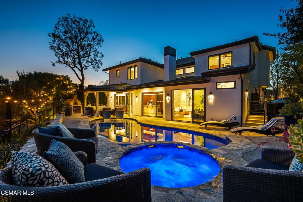 With commanding, panoramic south-facing views that stretch across the rugged expanse of the Santa Monica Mountains and down into the serene folds of Triunfo Creek, every glance south is a masterpiece of nature. This exquisite 4-bedroom, 3.5-bathroom home plus office underwent a full-scale remodel down to the studs in October 2020, seamlessly blending modern luxury with timeless design. Every detail has been thoughtfully considered--from the newer high-voltage electrical and plumbing systems to the Control4 smart home integration inside and out. Refinished maple wood floors run throughout, complemented by custom wood doors, seamless molding, and newer windows that flood the space with natural light. The chef's kitchen is a showstopper with top-of-the-line Miele appliances, a steam and speed oven, and a striking quartz island with raised butcher block bar seating. A lighted wine display backed with quartz anchors the custom bar area, with dual built-in wine refrigerators (accommodating 350 bottles). The primary suite is a true retreat, boasting a raised tongue & groove ceiling, dry sauna, soaking tub with mountain views, a supersized walk-in closet, shower and radiant heated floors. Step outside to your private oasis--an entertainer's dream featuring a saltwater pool with a baja shelf, new pool equipment (2020), two natural gas fire pits, built-in Lynx refrigerator & BBQ, pizza oven, and a covered outdoor lounge with heaters, TV, and premium sound. Built atop a rock quarry, the expansive deck ensures lasting stability and the forever views are sure to inspire. Additional features include a new HVAC with infrared purification (2024), a water HALO system, 9 security cameras, and ample garage storage. A true modern masterpiece.