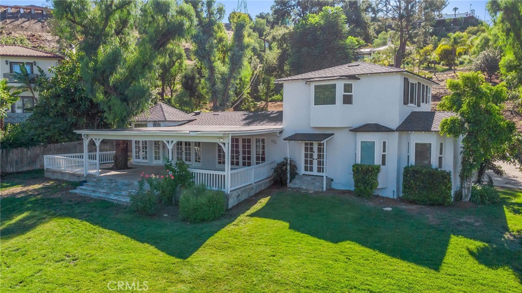 Tucked behind a private gate on a lush one-acre lot, this stunning 4-bed, 3.5-bath home offers ultimate privacy and indoor-outdoor living. An open floor plan features French doors throughout, a cozy fireplace, and a gourmet kitchen with granite countertops. Enjoy the beautiful front courtyard, spacious 600 sq ft covered patio, and sweeping views of the entire property—including a large gated pool. The fully insulated detached garage includes a finished 200 sq ft bonus space ideal for a gym, office, playroom, or studio. Move-in ready today!