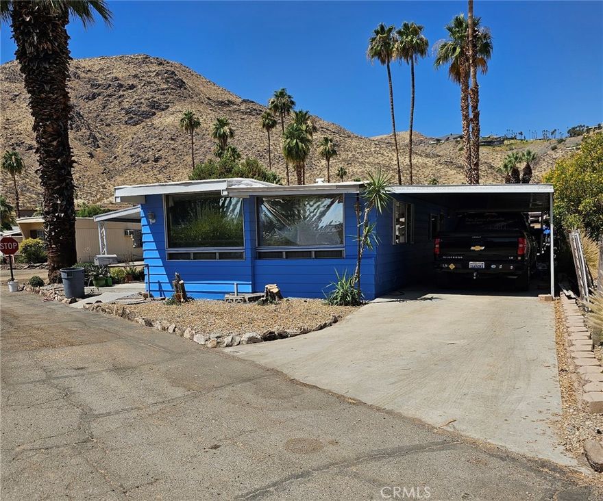 Spacious double wide mobilehome in Safari Park, a very sought after Palm Springs location.

Home has a very large bedroom, walk-in closet, wardrobe closet, ensuite bath with a new tile and glass walk in shower with 3 heads on wall selector (rainhead, wand, and conventional),and a bench seat. Hall bathroom with a walk-in shower. All new flooring. Carpeted bedroom and hardwood floors. Large corner lot with 2 covered areas. One carport and another side patio.