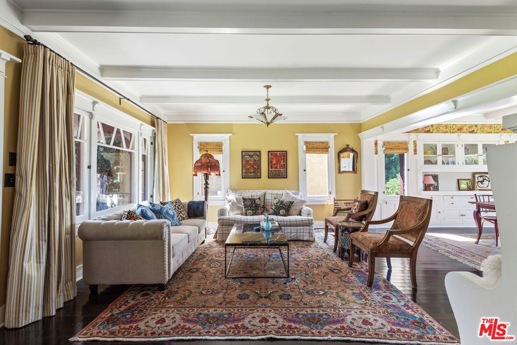 Gorgeous 1909 Craftsman which has been meticulously restored in the heart of Silver Lake. Beyond the hedges and relaxing front porch, enter through the original front door to an open floor plan with magnificent views, elegance, natural light, character built-ins, beamed ceilings and privacy. Pocket doors unveil a spacious sitting room complete with tin ceiling and speak-easy bar area. The large living room and stunning dining room overlooks the grassy yard and spectacular views. The kitchen features a fully stocked chef's dream boasting custom emerald colored cabinetry, microwave, toaster oven, dishwasher, coffee maker, country sink, European gas range and plenty of storage and prep area to create a gourmet meal. Upstairs, find three bedrooms, an office/daybed room with closet, an en-suite rose toned bedroom with queen bed and views of the historic neighborhood, and the primary bedroom featuring a luxurious king bed and sitting area with views to Century City plus an en-suite bath. The large grassy backyard with citrus trees is fully enclosed. Beautiful hardwood floors throughout and designer tile in kitchen and baths. Situated in the heart of Silverlake steps from shops, popular eateries Silverlake Ramen, All Day Baby, L&E Oyster, all of the excitement on Sunset Blvd and the Reservoir.